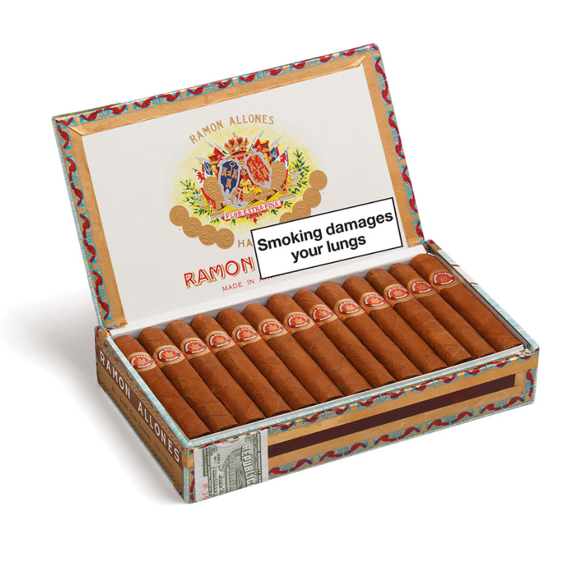 Open box of Ramon Allones cigars with visible branding and warning label.
