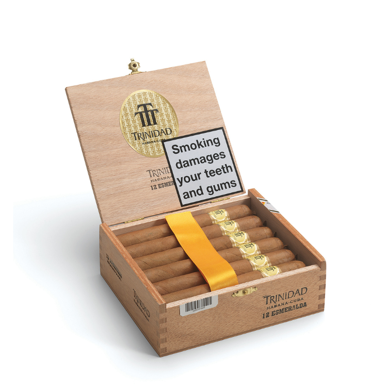Open Trinidad cigar box with cigars and warning label on a white background